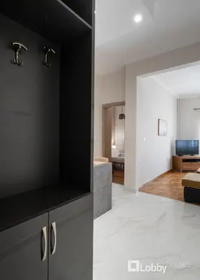 two images of a kitchen and a living room at Aria Apartment in Athens