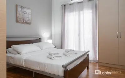 a bedroom with a bed with towels on it at Aria Apartment in Athens
