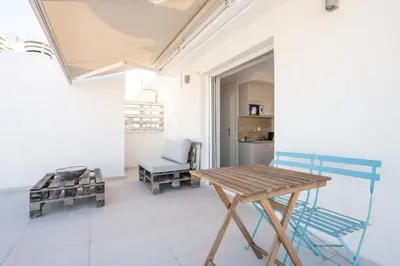 a room with a wooden table and a chair at RoofTop Sea View Cabin in Vari