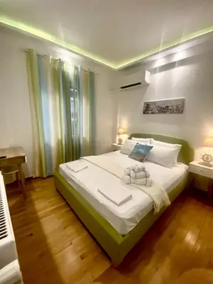 a bedroom with a large bed and a piano at Soul spa suites in Athens