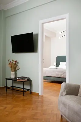 a living room with a bed and a couch and a mirror at Hospes - Chic retro retreat in the heart of Athens in Athens