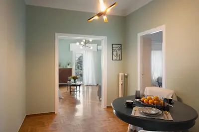 a living room with a table with oranges on it at Hospes - Chic retro retreat in the heart of Athens in Athens