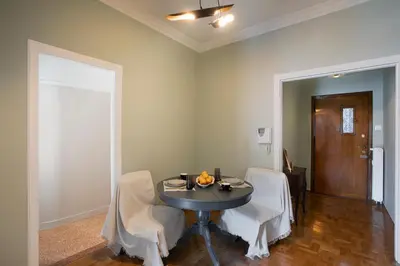 a dining room with a table and two chairs at Hospes - Chic retro retreat in the heart of Athens in Athens
