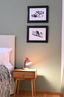 a bedroom with a bed and a table with a lamp at Stylish and spacious apartment in cool area in Athens