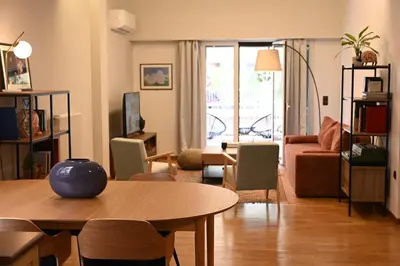 a living room with a table and a couch at Stylish and spacious apartment in cool area in Athens