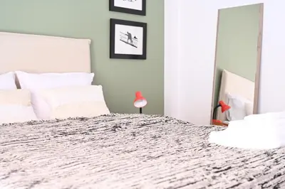 a bedroom with a large bed with white pillows at Stylish and spacious apartment in cool area in Athens