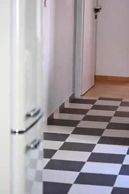 a hallway with a black and white checkered floor at Stylish and spacious apartment in cool area in Athens