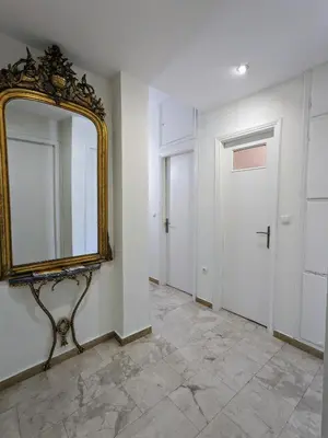 an empty hallway with a mirror and a door at Athenian Charm, Two-bedroom Flat in Athens