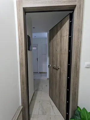 a wooden door in a room with a hallway at Athenian Charm, Two-bedroom Flat in Athens