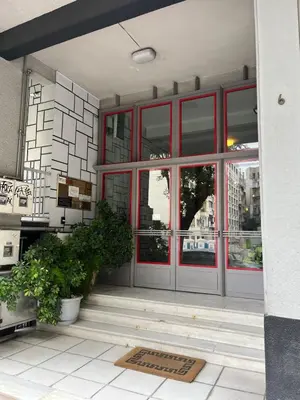 a front door of a building with red windows at Athenian Charm, Two-bedroom Flat in Athens