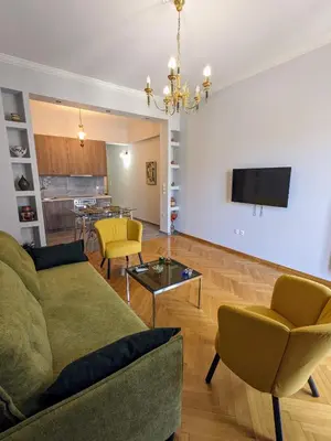 a living room with a couch and a table at Athenian Charm, Two-bedroom Flat in Athens
