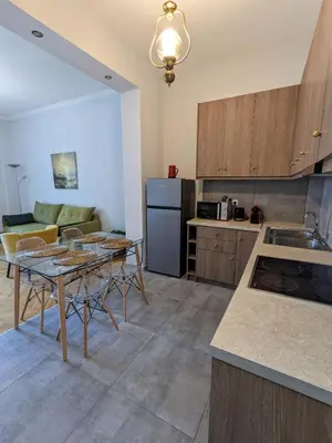 a kitchen with a table and a counter top at Athenian Charm, Two-bedroom Flat in Athens