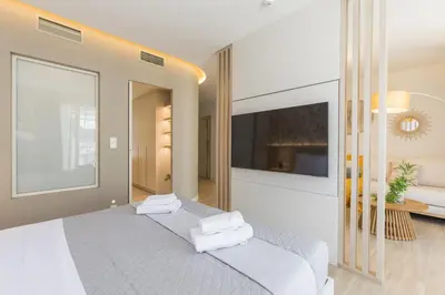 a bedroom with a bed with towels on it at The Mediterranean Suites in Piraeus