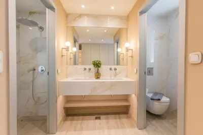 a bathroom with a sink and a shower and a toilet at The Mediterranean Suites in Piraeus