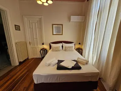 a bedroom with a bed with two towels on it at Acropolis Eternal Mansion by YHA in Athens
