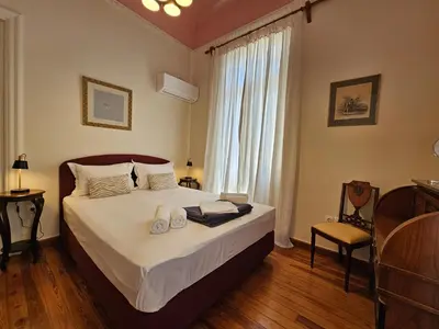 a bedroom with a bed with two towels on it at Acropolis Eternal Mansion by YHA in Athens