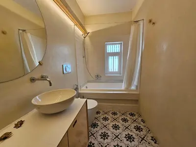 a bathroom with a sink and a toilet and a tub at Acropolis Eternal Mansion by YHA in Athens