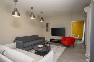 a living room with a couch and a tv at LIV - Sunny Penthouse Near Acropolis in Athens