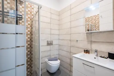 a bathroom with a toilet and a sink at LIV - Sunny Penthouse Near Acropolis in Athens