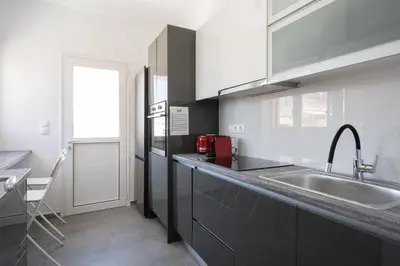 a kitchen with a sink and a counter top at LIV - Sunny Penthouse Near Acropolis in Athens
