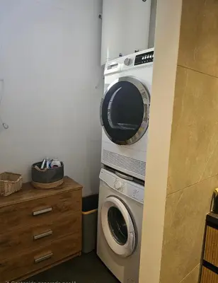 a kitchen with a washing machine and a microwave at Riviera Bliss in Athens
