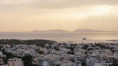 a view of a city with a ship in the water at Riviera Bliss in Athens