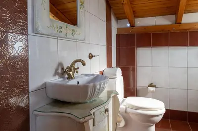 a bathroom with a sink and a toilet at Villa Galano - Your Cozy Retreat In The Athenian Riviera in Vari