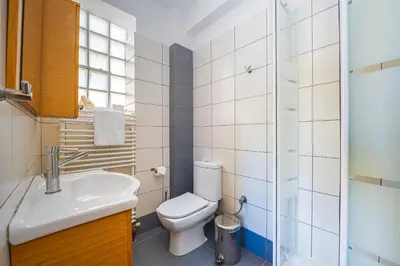 a bathroom with a toilet and a sink and a shower at Villa Galano - Your Cozy Retreat In The Athenian Riviera in Vari