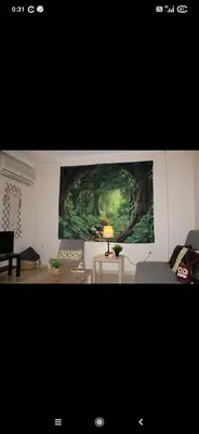 a living room with a painting on the wall at Modern Apartment in Athens in Athens