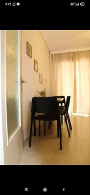 a table and chairs in a room with a window at Modern Apartment in Athens in Athens