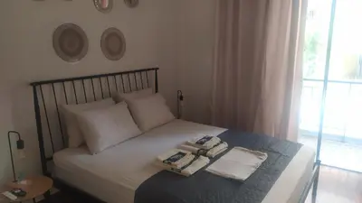 a bedroom with a bed with two towels on it at Modern Apartment in Athens in Athens