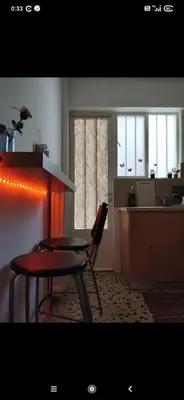 a room with a table and a chair and a kitchen at Modern Apartment in Athens in Athens
