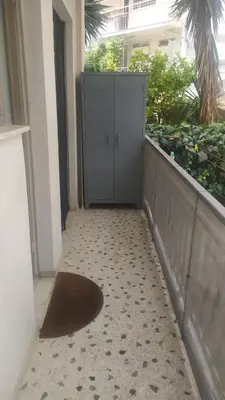 a hallway with a door and a rug on a floor at Modern Apartment in Athens in Athens