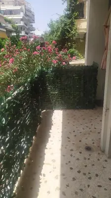 a garden with pink flowers in a building at Modern Apartment in Athens in Athens