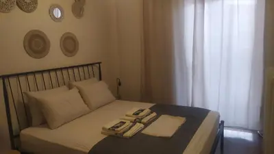 a bedroom with a bed with two phones on it at Modern Apartment in Athens in Athens
