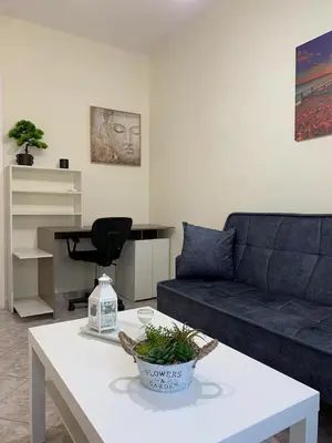 a living room with a couch and a table at Apartment near Piraeus port in Piraeus