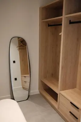 a mirror in a bedroom with wooden shelves at Urbanlux Boutique Apartments in Athens