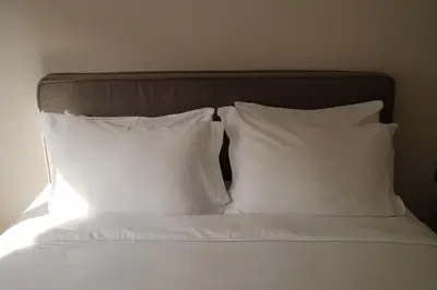 a bed with two white pillows on top of it at Urbanlux Boutique Apartments in Athens