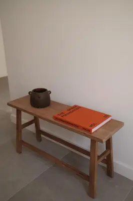 a book and a pot sitting on a wooden table at Urbanlux Boutique Apartments in Athens