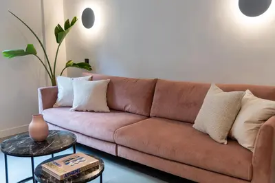 a brown couch in a living room with a table at Urbanlux Boutique Apartments in Athens