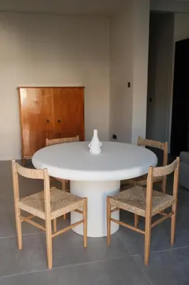a white table with two chairs and a vase on top at Urbanlux Boutique Apartments in Athens