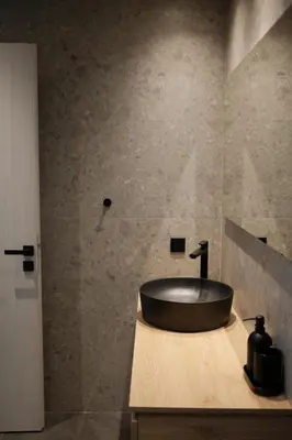 a bathroom with a black sink on a counter at Urbanlux Boutique Apartments in Athens
