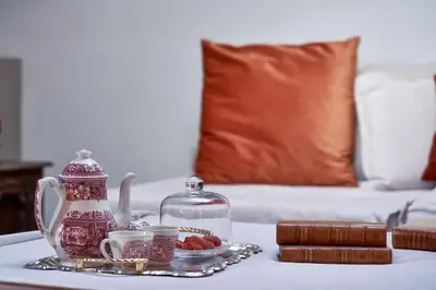 a table with a tray with a tea kettle and cups at Emporikon Athens Hotel in Athens