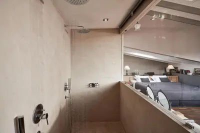 a staircase leading to a bedroom with a bed at Emporikon Athens Hotel in Athens