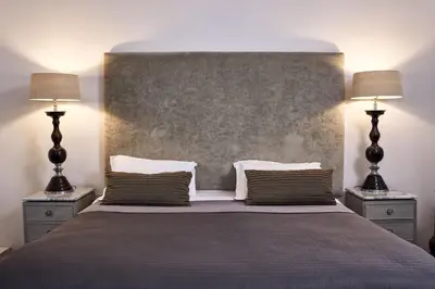 a bedroom with a large bed with two lamps at Emporikon Athens Hotel in Athens