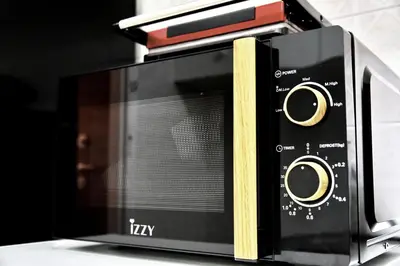 a microwave oven sitting on top of a counter at Kipseli NEW MoDeRN & CoZy 65TV Netflix in Athens