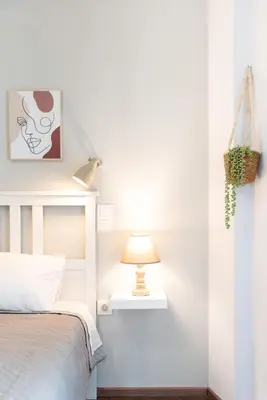 a bedroom with a bed and a lamp at Vibrant apartment next to Acropolis in Athens
