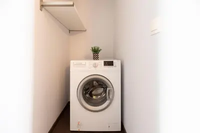 a washer and dryer in a corner of a room at Vibrant apartment next to Acropolis in Athens