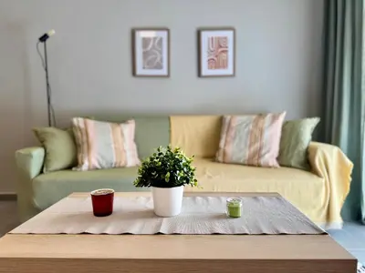 a coffee table with a potted plant on top of it at Comfort Downtown Marble, Koukaki Athens in Athens