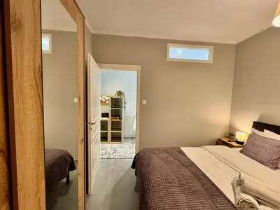 a small bedroom with a bed and a mirror at Comfort Downtown Marble, Koukaki Athens in Athens